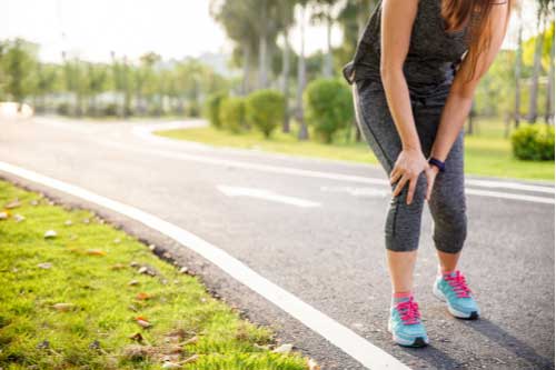 Jogger with knee injury, concept of Naples Muscle Strains Treatment