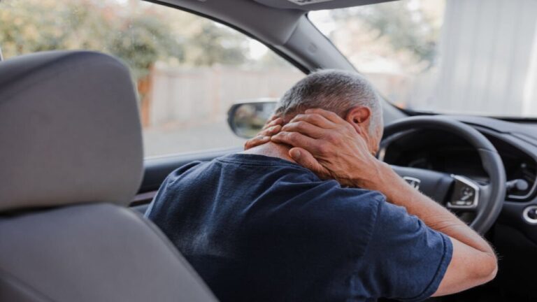 Middle-aged man with neck pain Inside the Car