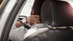 Man Having Neck Pain While Driving a Car