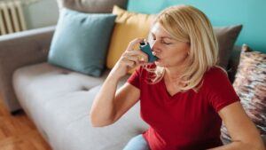 Senior Woman in Her Late 50s Inhaling Asthmatic Cure at Home
