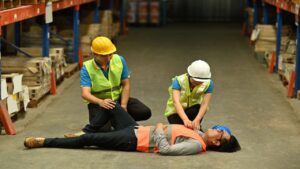 Warehouse Worker Lying Unconscious on the Concrete Floor 