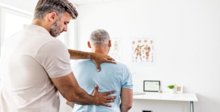 Chiropractor Doing Back Adjustment for His Man Client