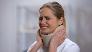 Injured Female in a Foam Cervical Collar Suddenly Feeling Pain in Her Neck