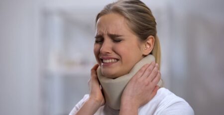 Injured Female in a Foam Cervical Collar Suddenly Feeling Pain in Her Neck
