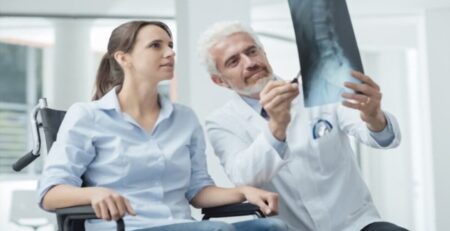 Radiologist Examining Woman's Xray